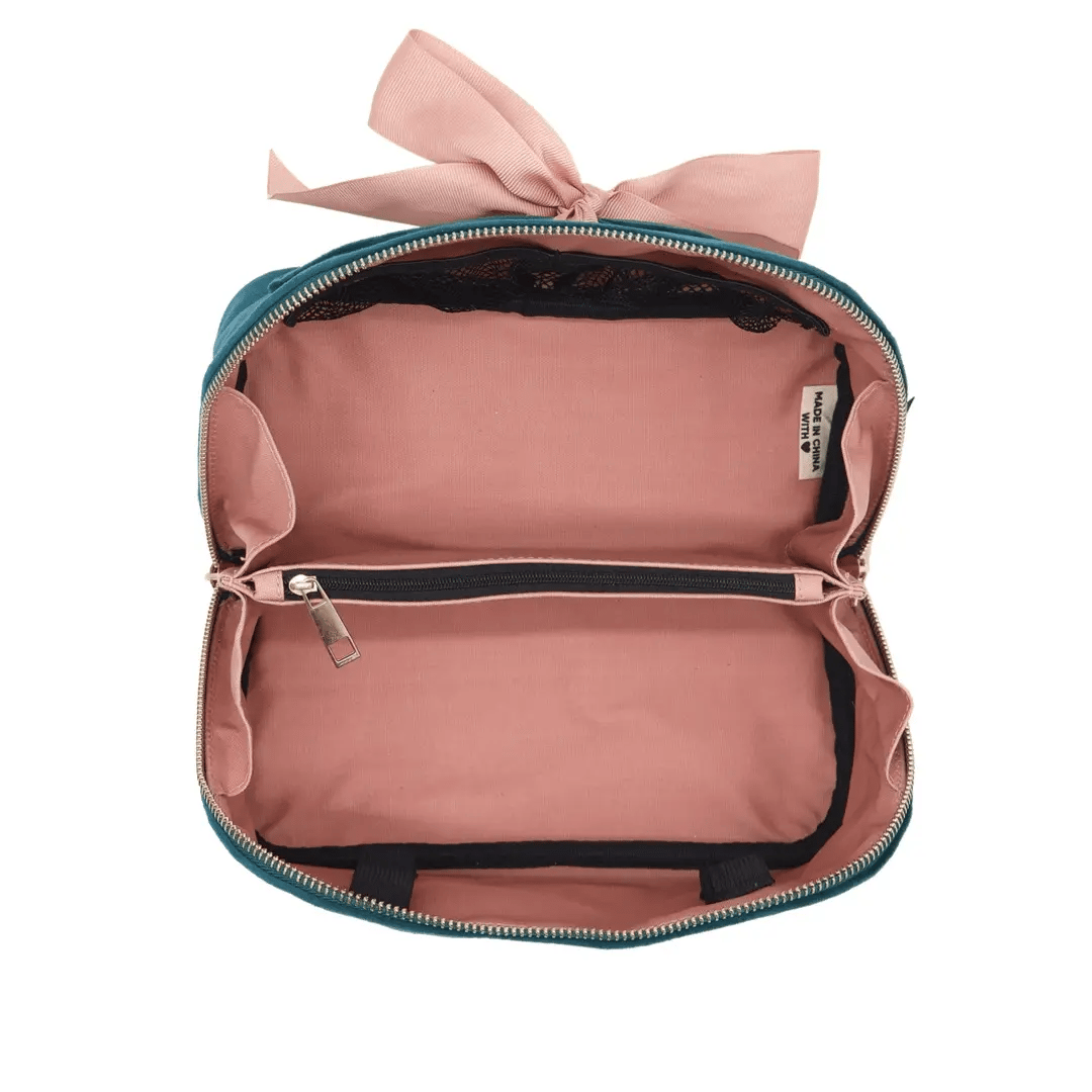 Bag-all pink travel organization pouch with a bow tie and multiple zippered compartments for organized packing