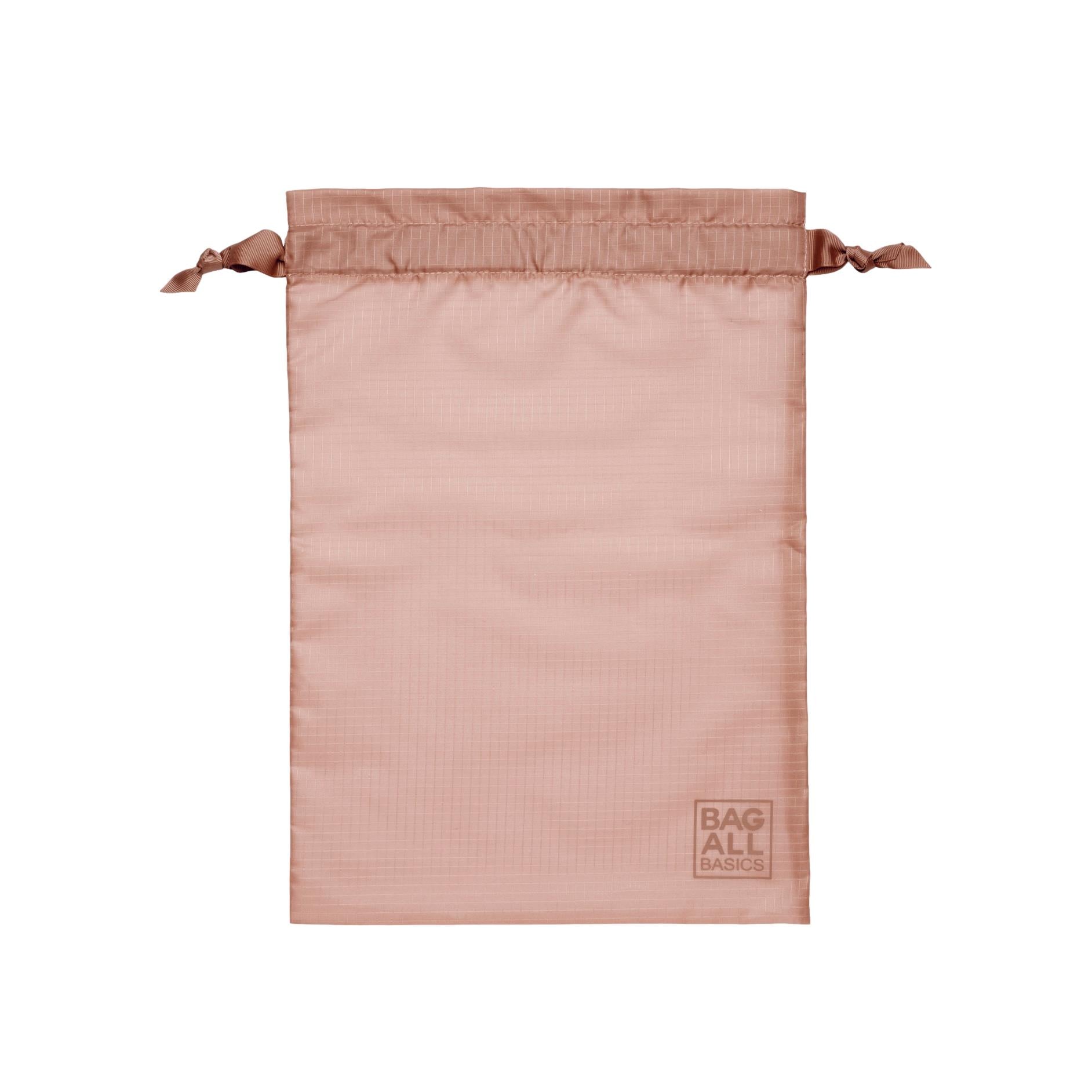 Bag-all Compression Cubes & Packing Bags Set in pink blush, featuring recycled nylon drawstring bag with embossed logo for sustainable travel organization