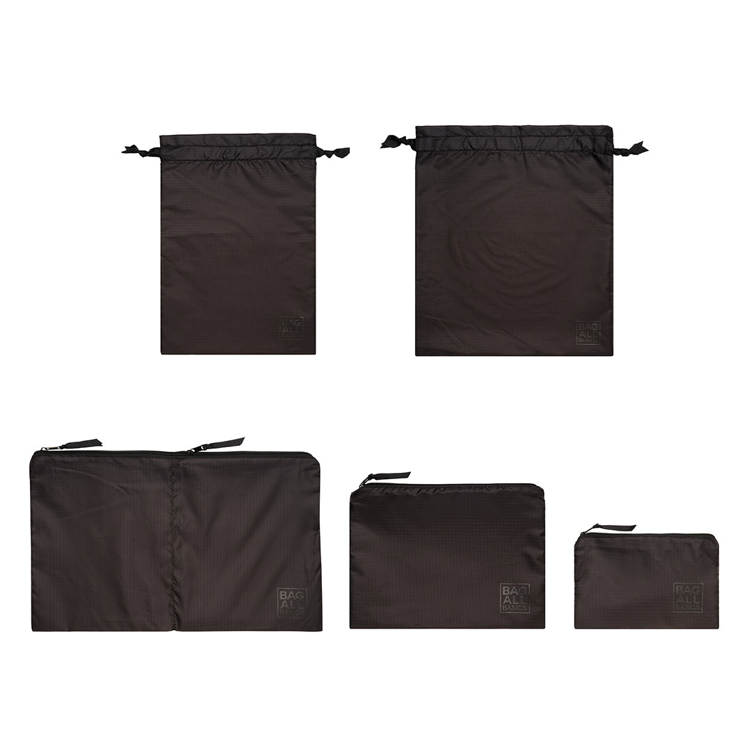 Bag-all Packing Bags Set in recycled nylon featuring 5 black organizer bags - two drawstring pouches and three zippered cases in varying sizes for efficient travel storage and organization
