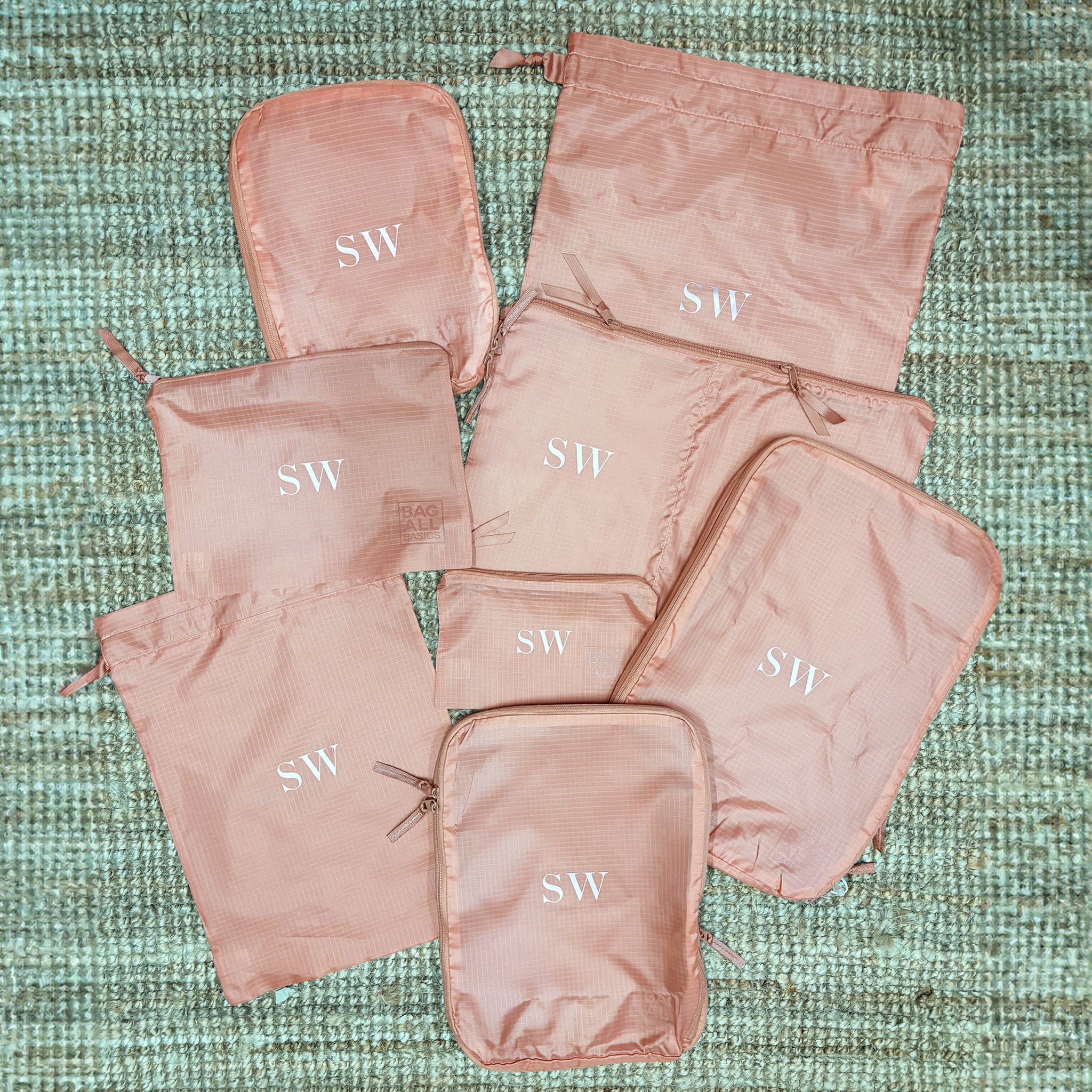 Bag-all Compression Cubes & Packing Bags Set in pink/blush with monogrammed SW initials, featuring 8 eco-friendly nylon organizers for efficient travel packing and storage