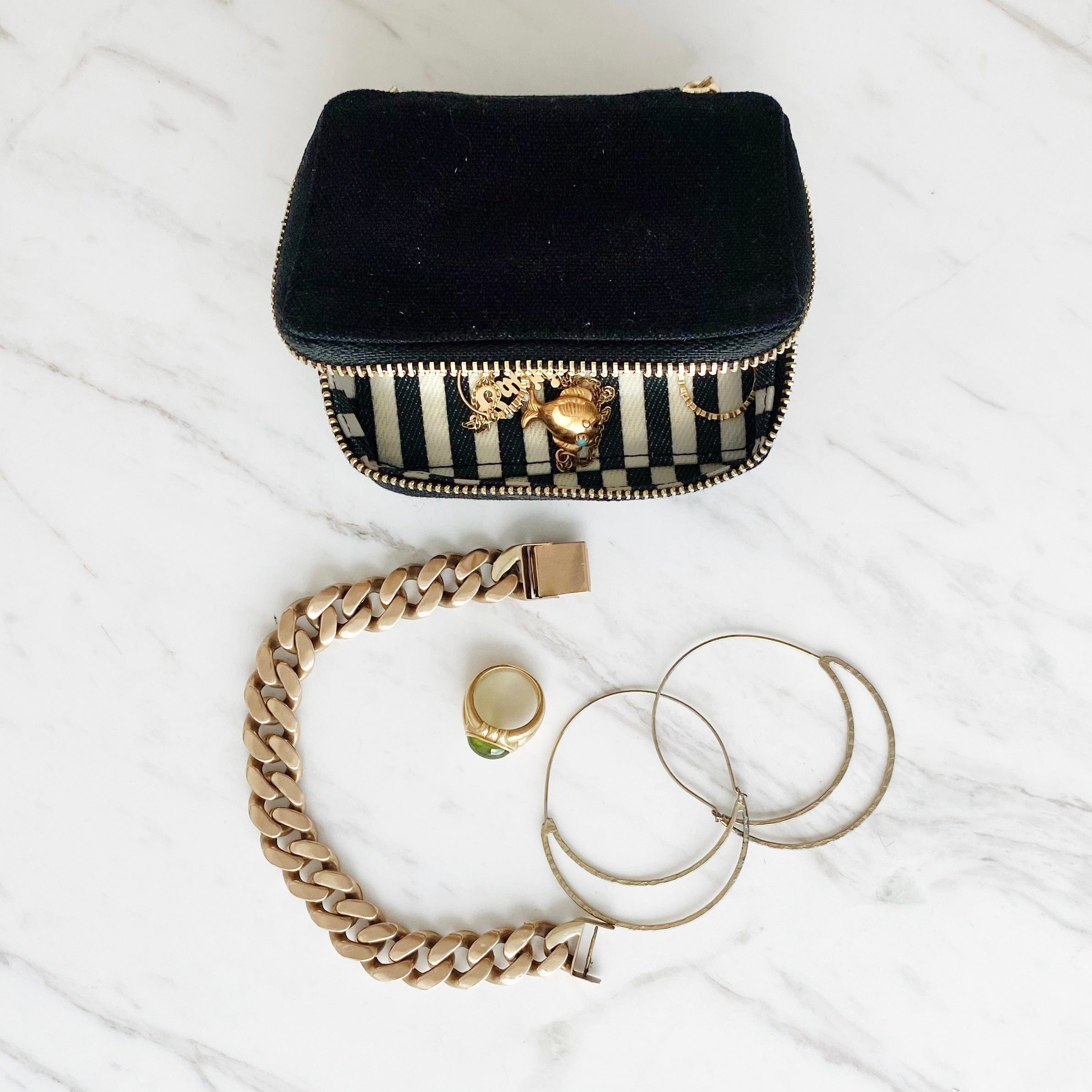 Bag-all Black Velvet Handbag Organizer Trio with striped interior, shown with gold jewelry including bracelet, ring and hoop earrings on marble surface