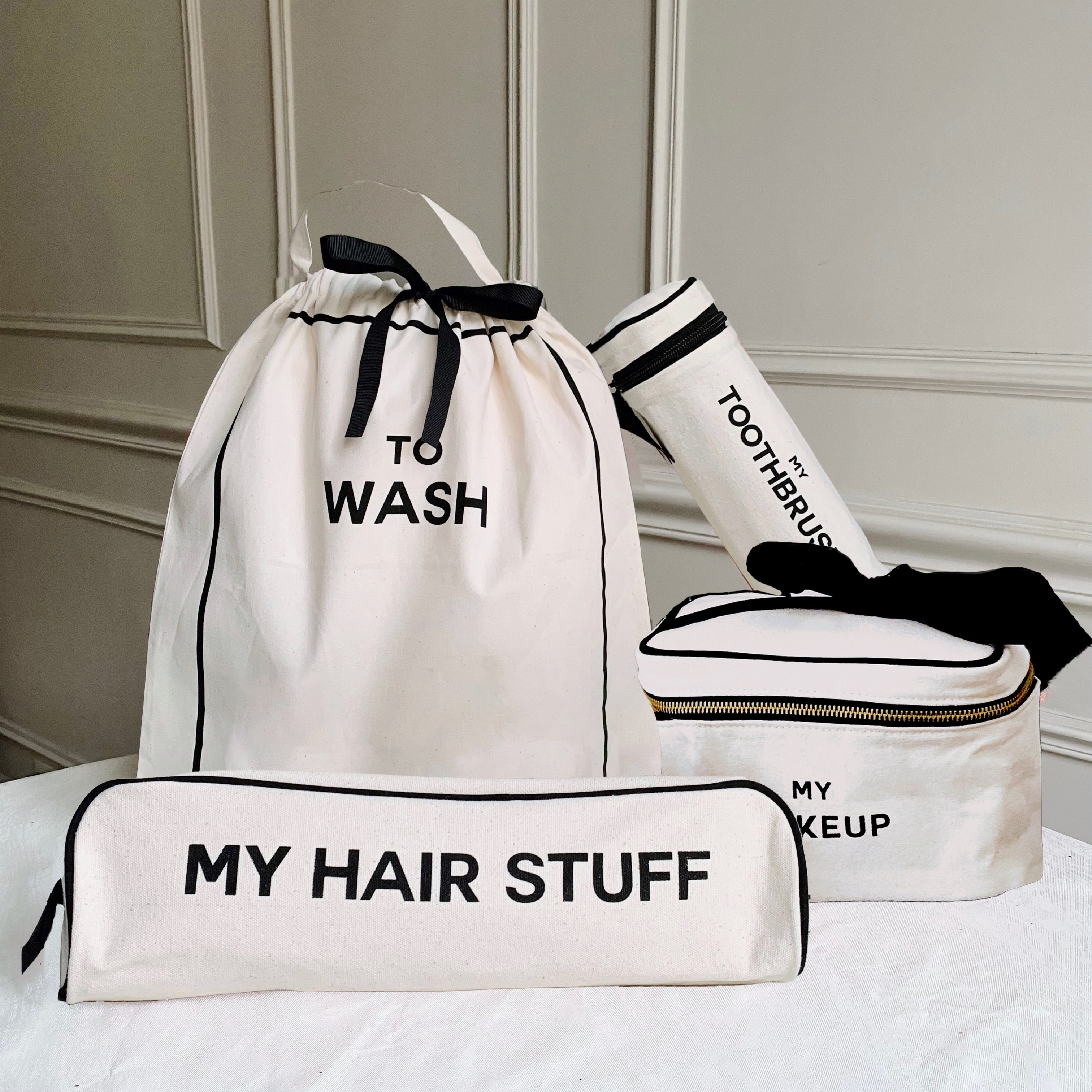 Bag-all Deal Gift Set featuring cream cotton travel organizers - To Wash laundry bag, My Hair Stuff case, toothbrush holder, and makeup box with black trim and waterproof striped lining