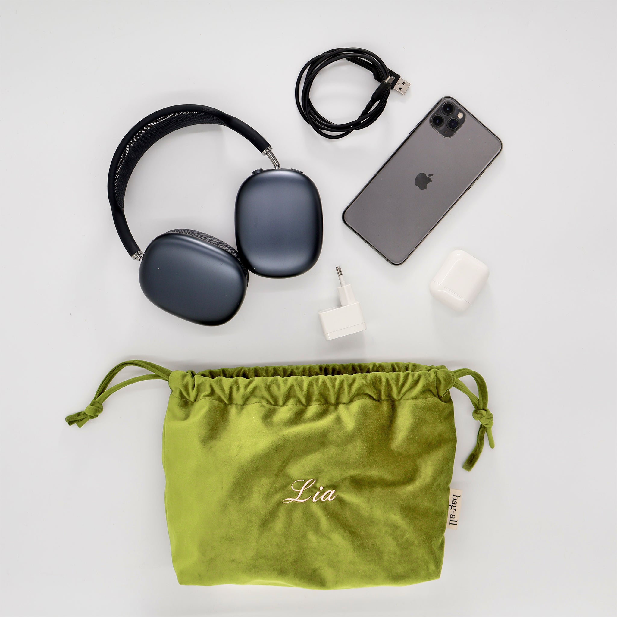 Green velvet drawstring tech pouch by Bag-all with personalized name Lia for storing headphones phone charger and earbuds