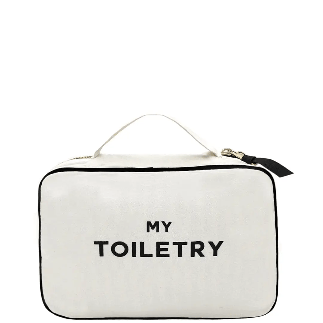 Bag-all Folding Toiletry Case in cream with 'MY TOILETRY' text, featuring black trim, hanging ribbon, and three compartments for organized travel storage