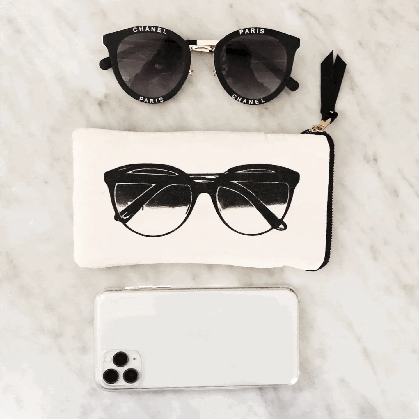 Bag-all Glasses Case with Outside Pocket in cream featuring stylish black sunglasses print on marble background with designer eyewear and phone accessory styling