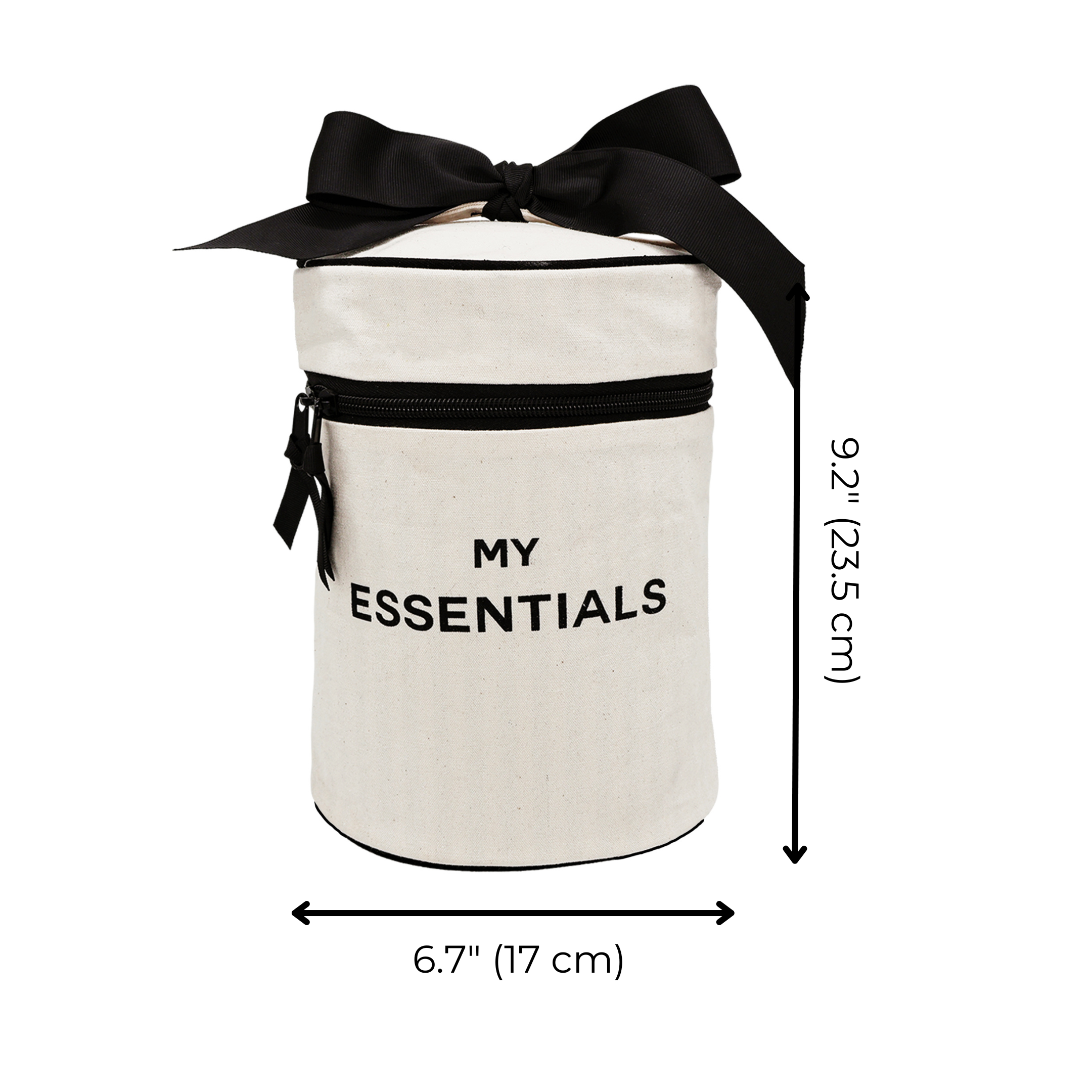 Bag-all Roomy Travel Essentials Case in cream with black bow, cylindrical shape, black zipper pocket and "MY ESSENTIALS" text. Round cotton case with waterproof lining, 9.2x6.7 inches.