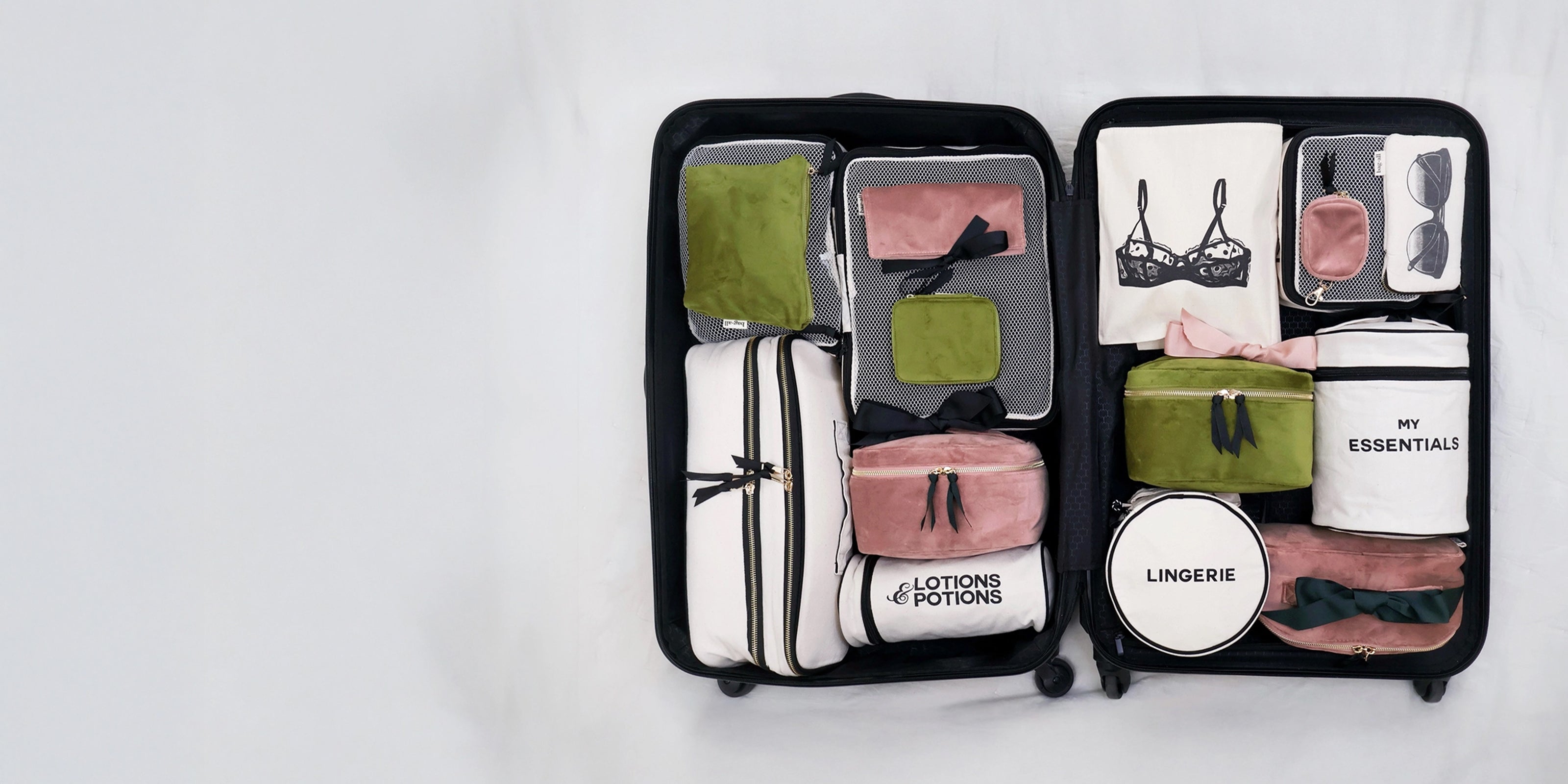 Open suitcase with Bag-all organizers in green, pink, and white neatly sorting essentials and lingerie gallery position 1