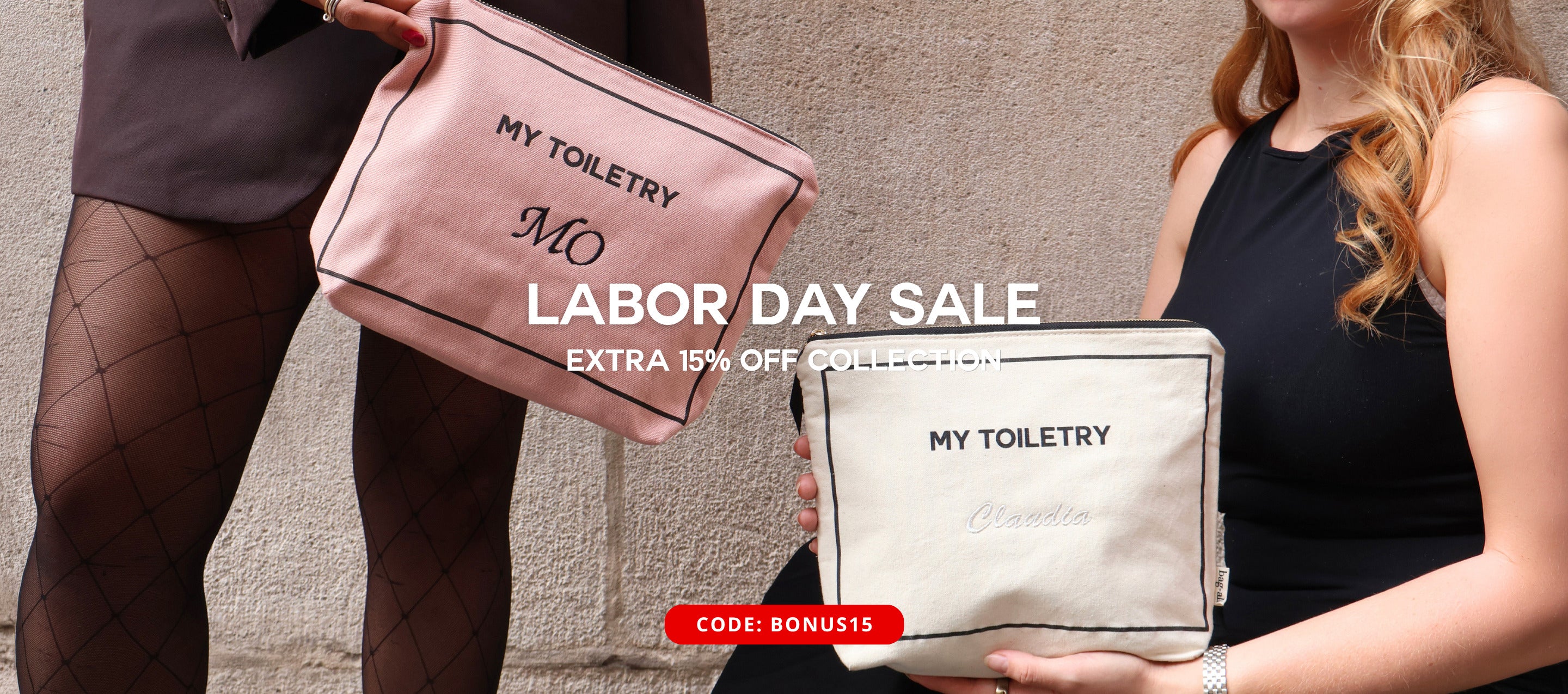 Bag-all personalized cotton toiletry bags held by models against a textured wall for travel organization