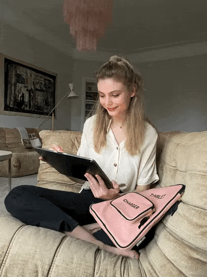 Bag-all Pink Tablet Case 11" with Charger Pocket shown on couch, featuring stylish blush color and practical front pocket design, perfect for protective tablet storage