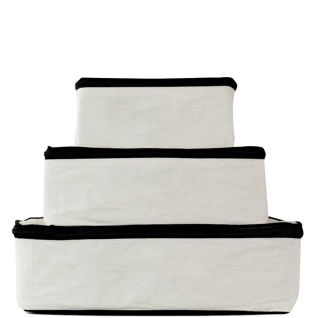 Bag-all Travel Glam 4-Pack in cream cotton - stackable organizer pouches for clothing, lingerie, makeup, and tech accessories, featuring black trim and zipper closures