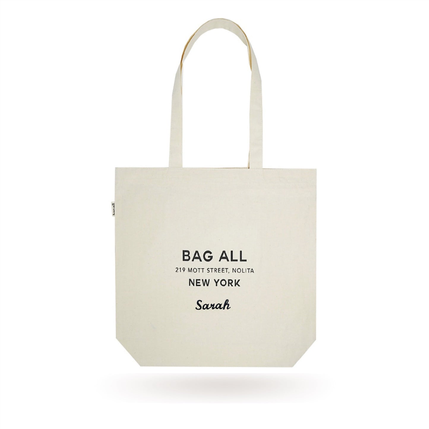 Bag-all New York City Tote with Zipper, cream cotton canvas tote bag featuring long handles, interior pocket, and classic Bag-all logo print for everyday use