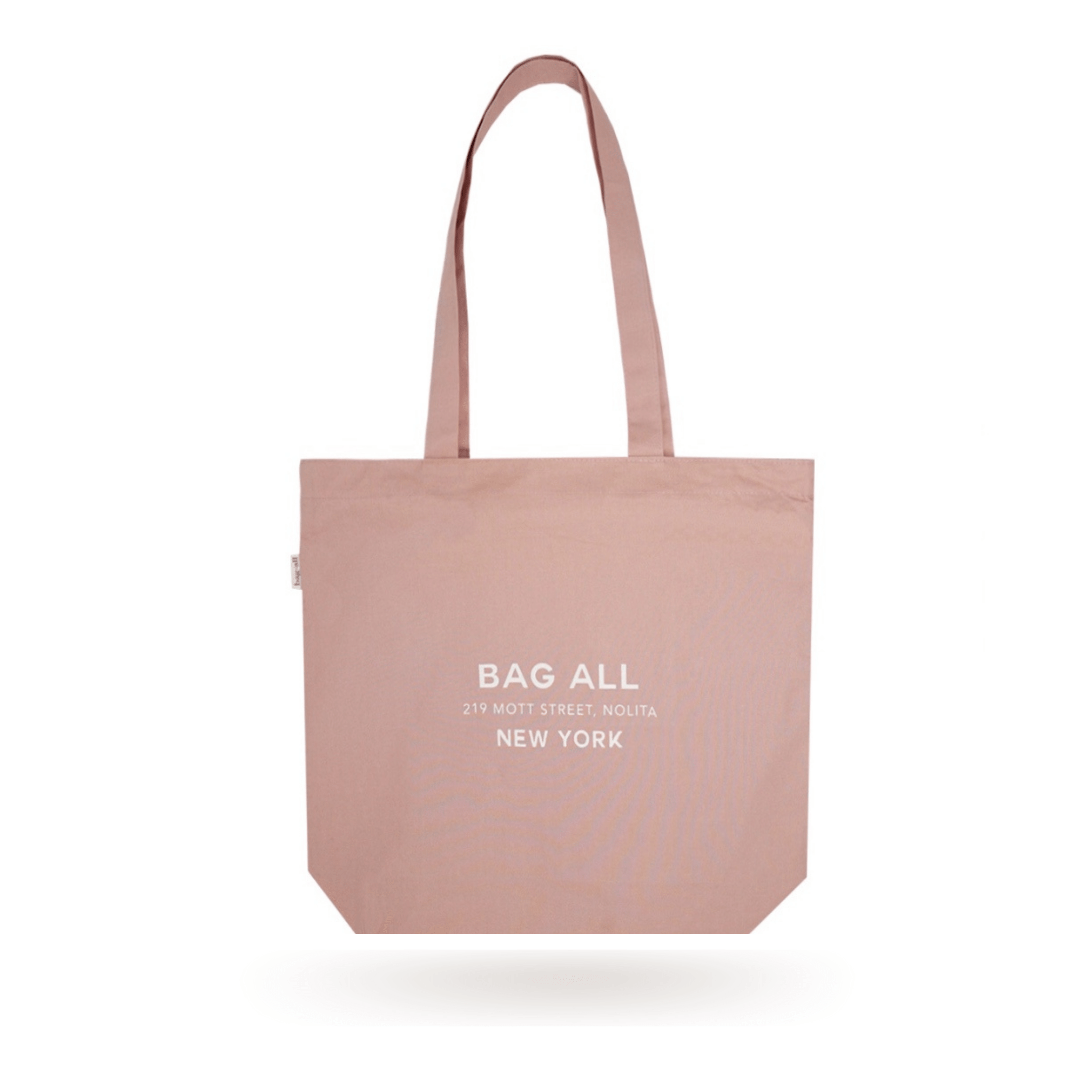 Bag-all New York City Tote in pink blush cotton with zipper and interior pocket, featuring minimalist design and white logo print, perfect for sustainable everyday carry