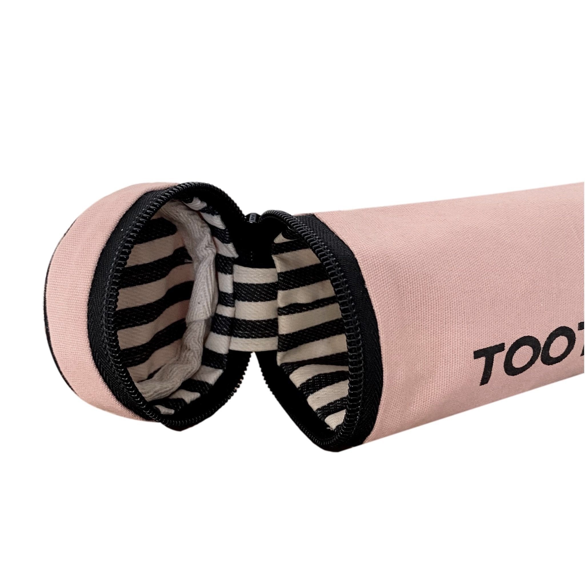 The zippered opening to the travel pink toothbrush case. 