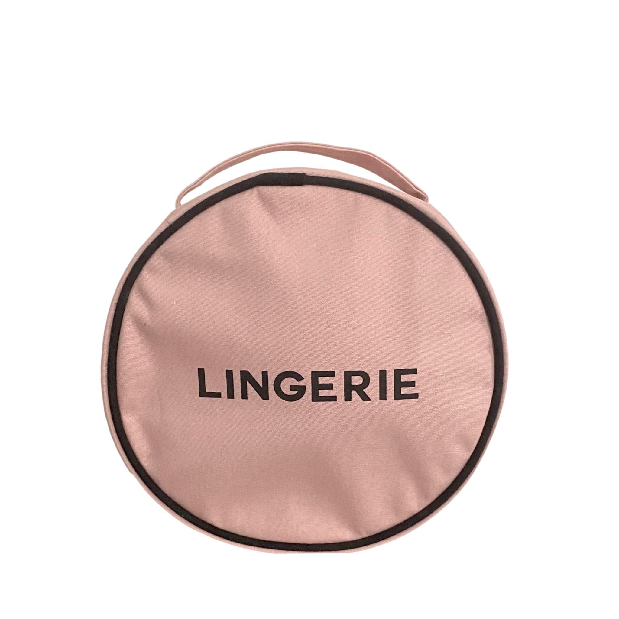 Bag-all Round Lingerie Case in blush pink cotton, featuring black trim and text, metal zipper, perfect for travel organization and stylish storage