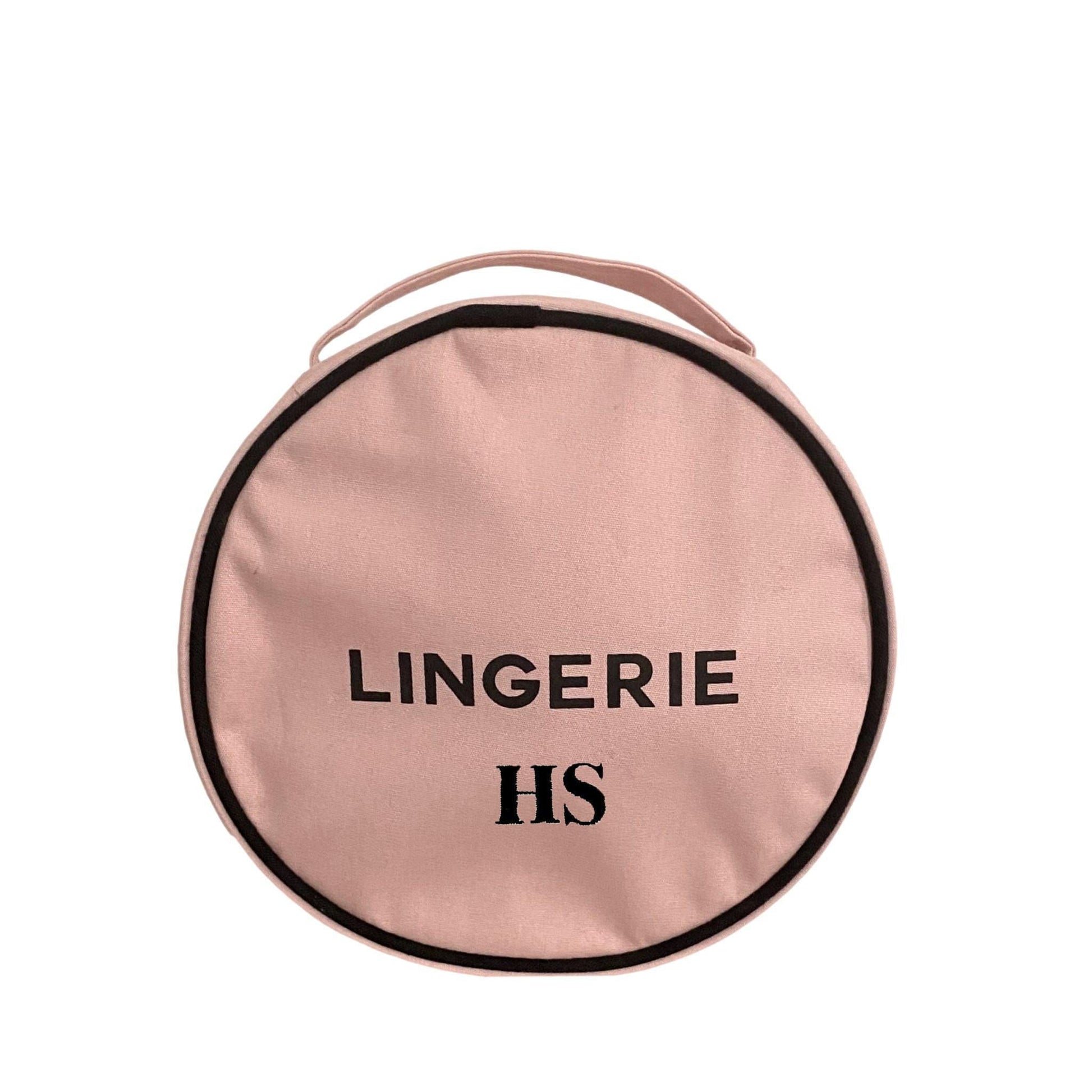 Bag-all Round Lingerie Case in blush pink cotton with black trim and text, featuring metal zipper and custom black-white interior lining - perfect for travel organization