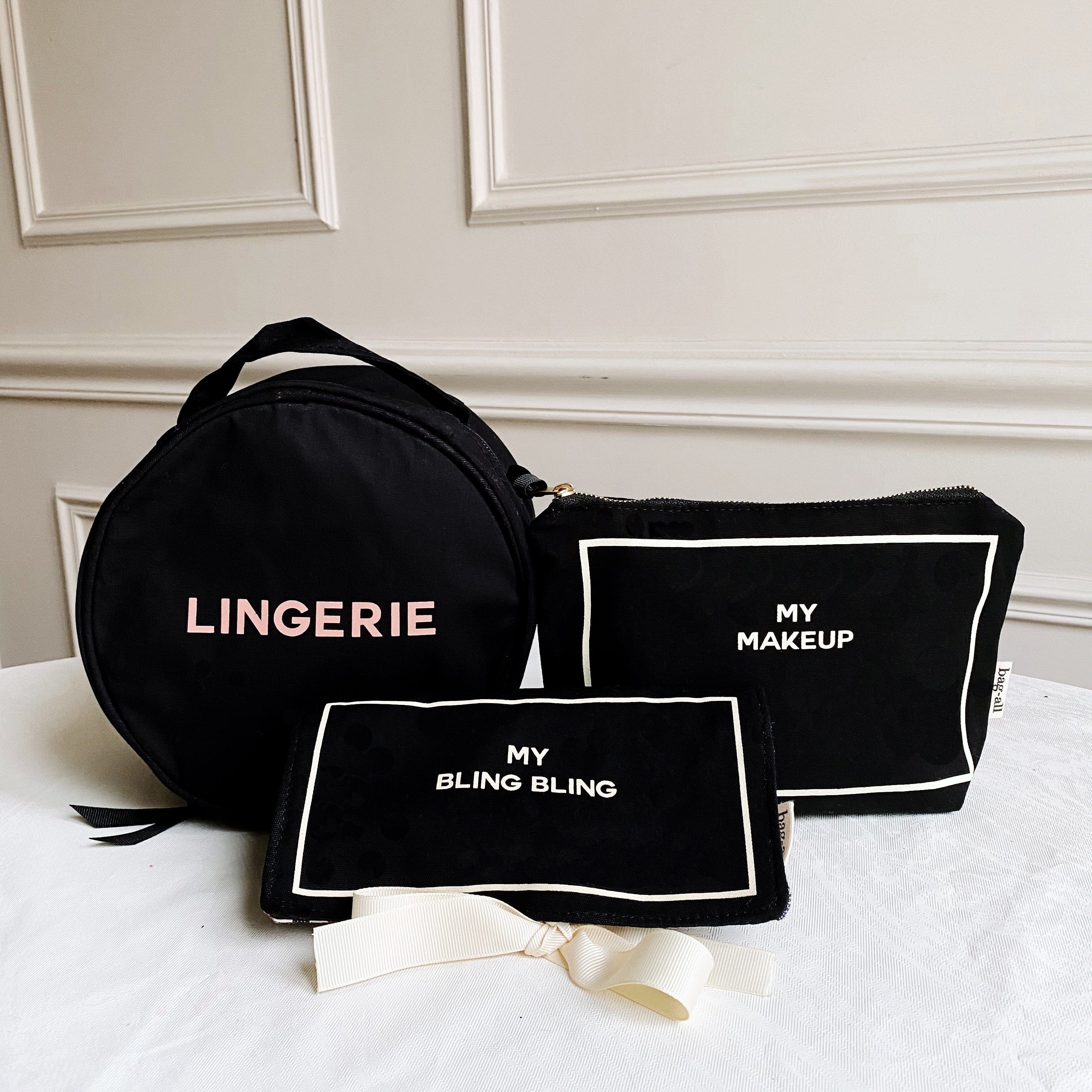 Bag-all Deal Gift Set for Her: Black cotton travel organizers featuring Round Lingerie Case, Jewelry Case, and Makeup Case with elegant white text labels and striped interior lining