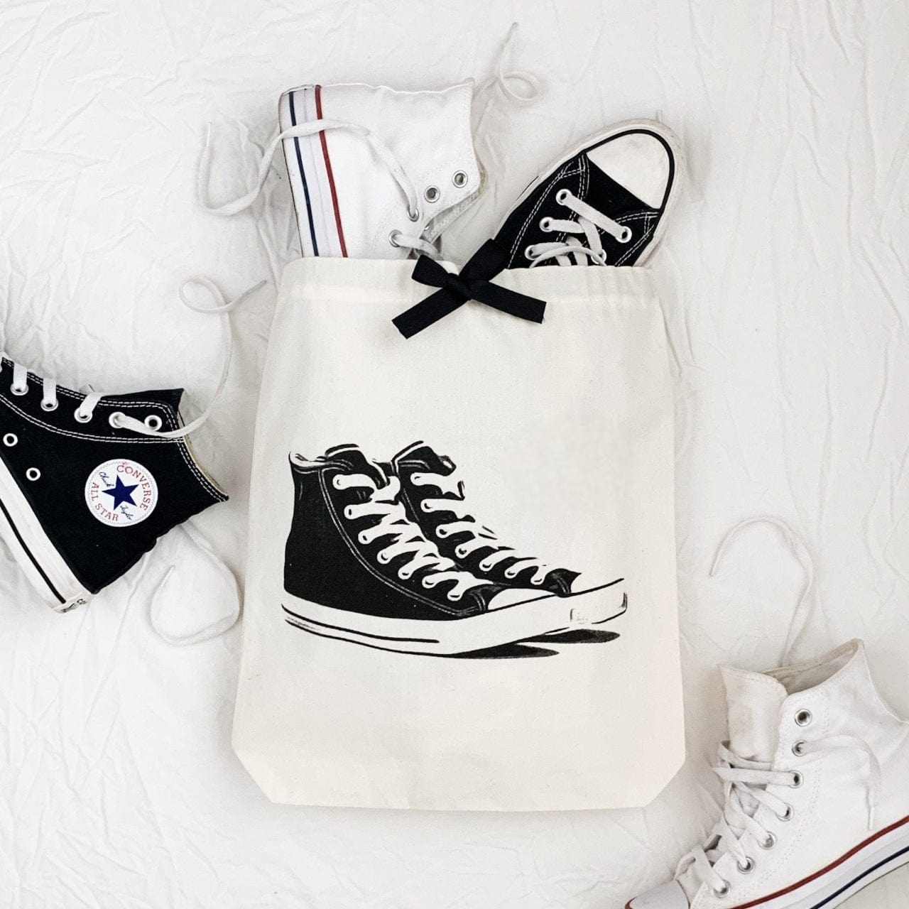 Bag-all Cream Sneakers Shoe Bag featuring classic high-top sneaker print, stylish black bow detail, perfect for organizing and protecting footwear during travel or storage