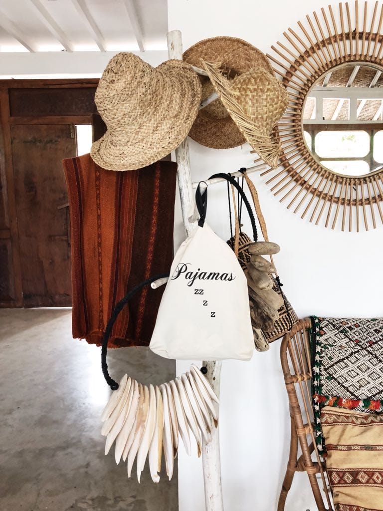 Bag-all cream cotton drawstring Pajamas Zzzz Travel Bag with hanging loop, perfect for organizing sleepwear at home or during travels, shown alongside decorative straw hats and rattan mirror