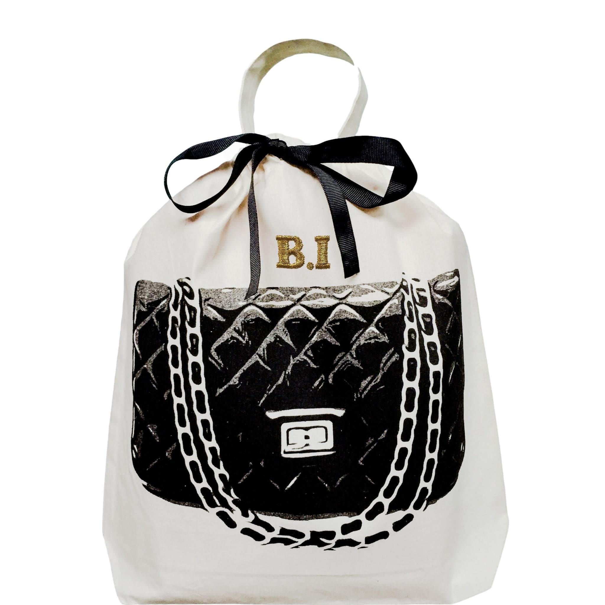 Bag-all Quilted Handbag Travel Bag in cream with black designer purse illustration, black ribbon bow, and personalized gold monogram, perfect for luxury handbag storage and protection
