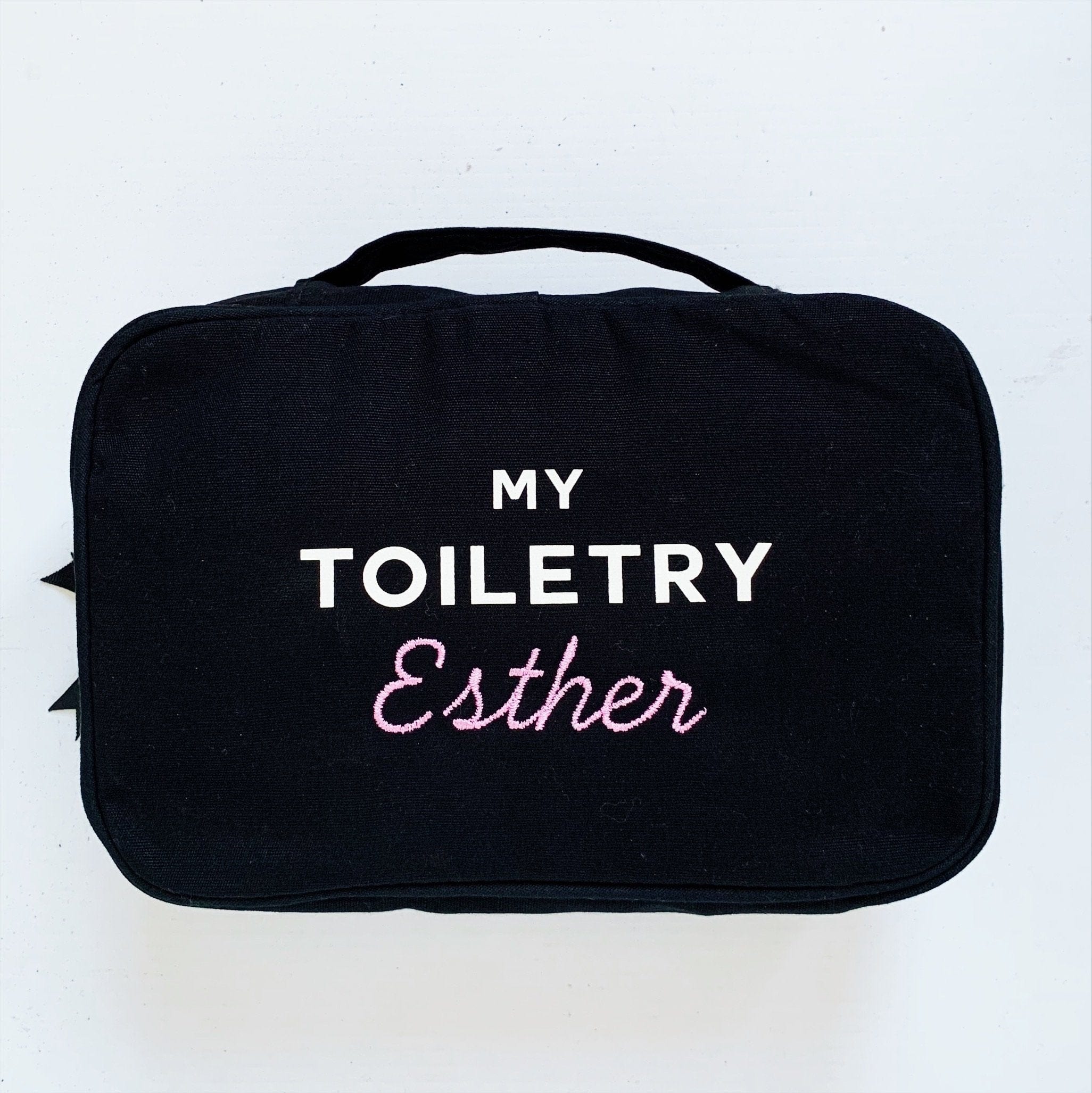My toiletry case with "Esther" monogrammed on the front.
