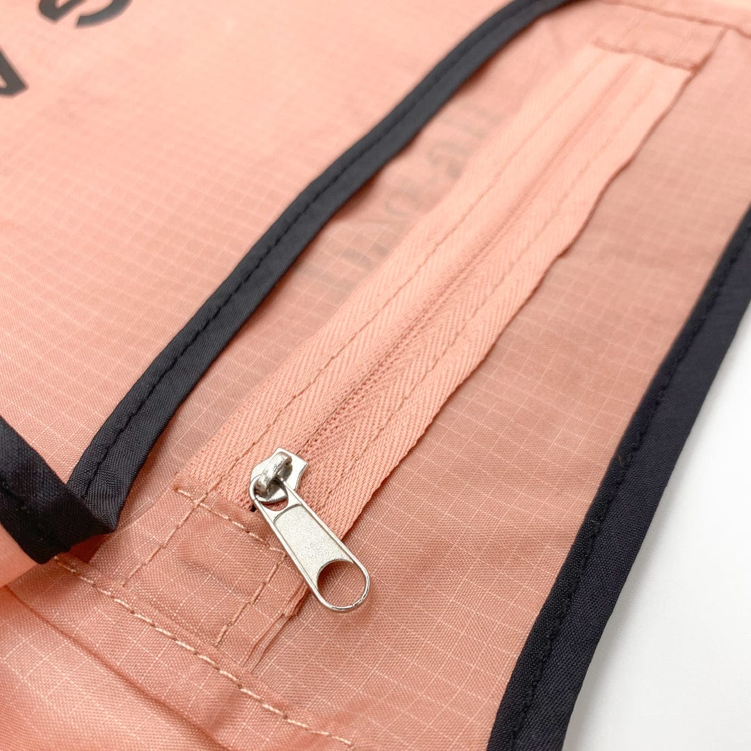 Bag-all Folding Shopping Bag with pink ripstop nylon material featuring black trim and secure metal zipper closure on attached pouch pocket, showcasing durable reinforced stitching details