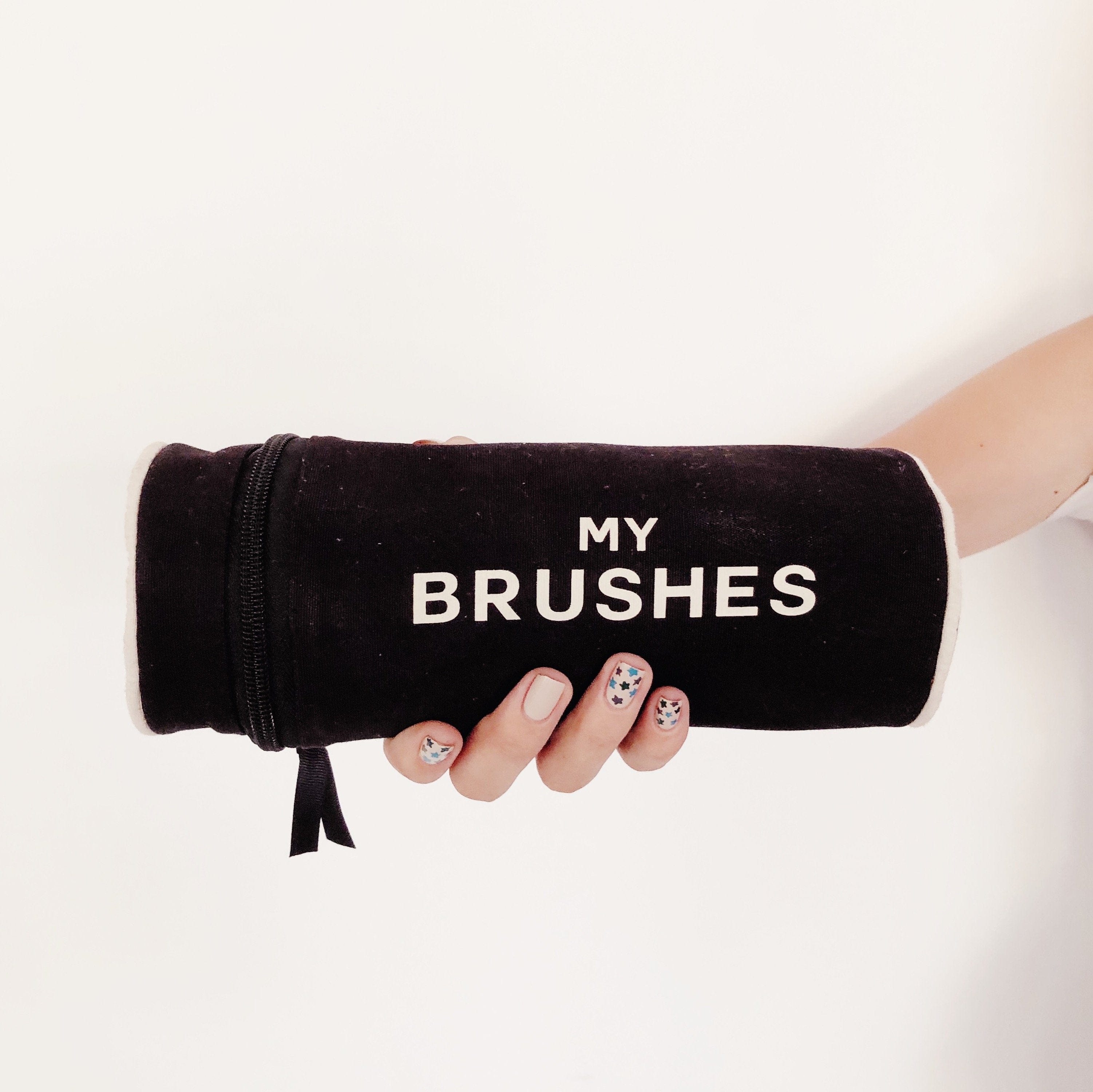 Bag-all Black Cylinder Brush Case with "MY BRUSHES" text, stylish storage solution for makeup and hair brushes, features zippered closure and protective fabric