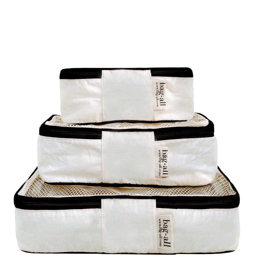 Bag-all Cotton Packing Cubes in cream with black trim, set of 3 nested sizes featuring mesh tops for visibility and breathability, perfect for organized travel storage