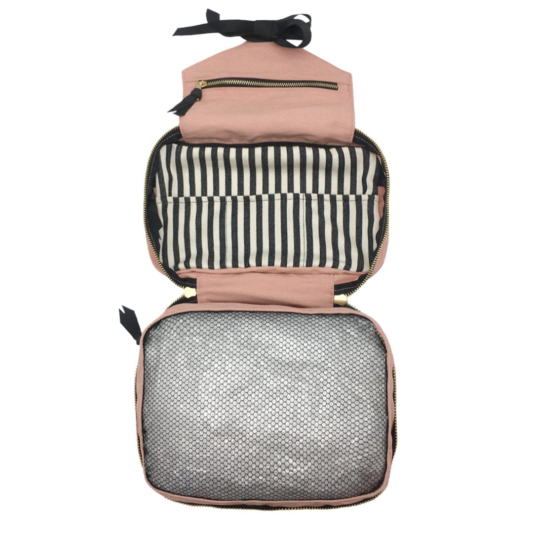 Bag-all Folding Toiletry Case in blush pink with striped interior compartment and mesh storage, featuring hanging ribbon and multiple organizing sections for travel essentials
