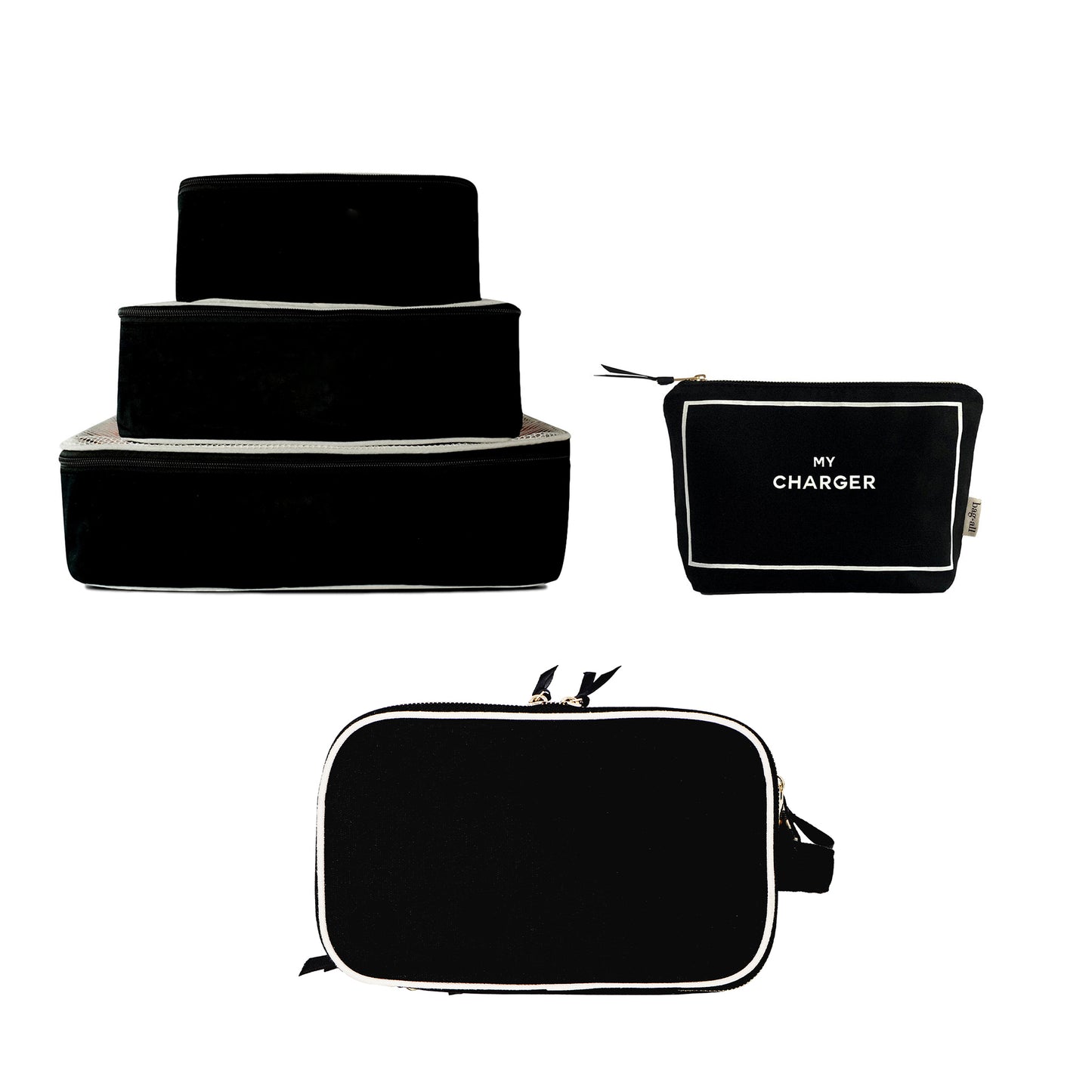 Set of three black Bag-all packing cubes stacked with black toiletry and tech organizers including My Charger pouch