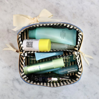 Bag-all Accordion Box Makeup & Toiletry in denim with striped interior holding skincare and beauty products neatly organized
