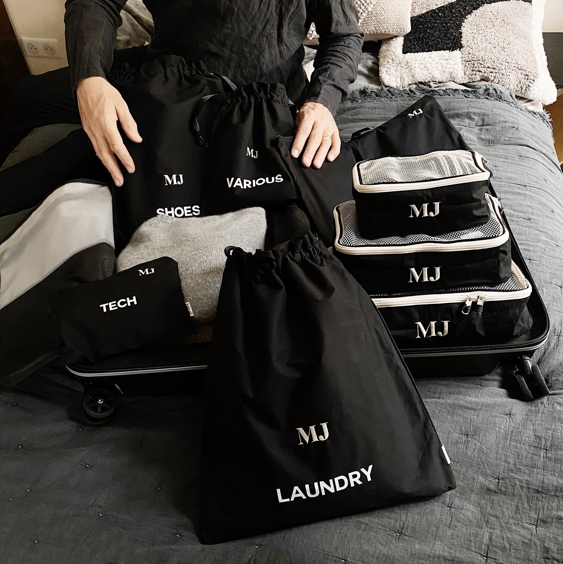 Bag-all BA Travel Set, 8-Pack in Black with personalized monogram ‘MJ’. Includes packing cubes, shoe, laundry, tech, and various bags