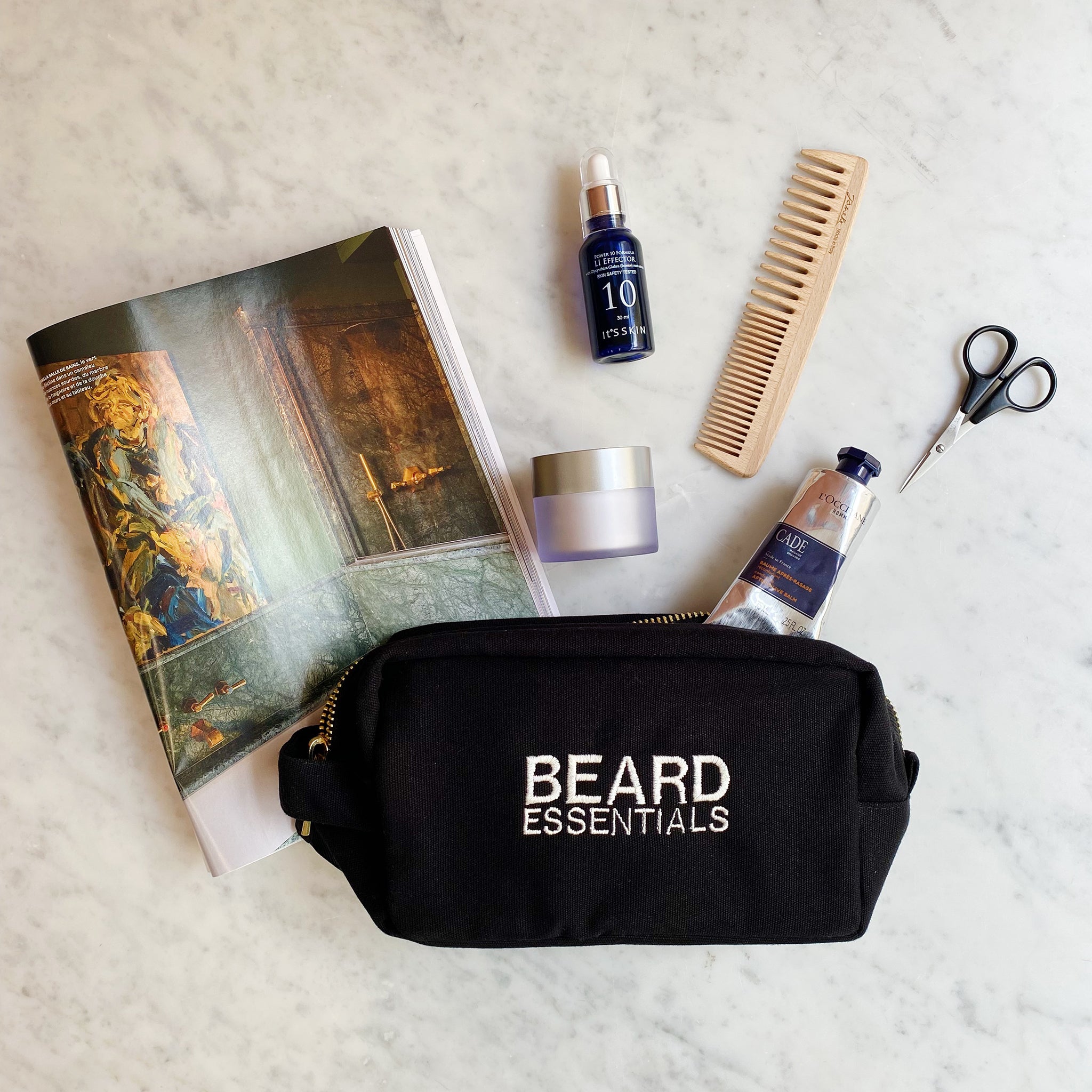 Bag-all Beard Essentials Pouch in black with grooming tools, beard oil, and comb. Stylish travel pouch for beard care products