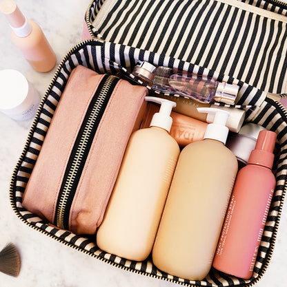 Bag-all pink blush 3-pack beauty and medicine organizers in striped travel case with skincare bottles neatly arranged