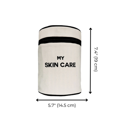 Bag-all Round My Skin Care Case in cream, cylindrical organizer with black trim and text, featuring laminated lining and internal pockets for beauty products
