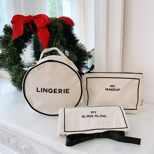 Cream Bag-all 3-pack gift set including lingerie, makeup, and jewelry cases with holiday wreath and red bow background