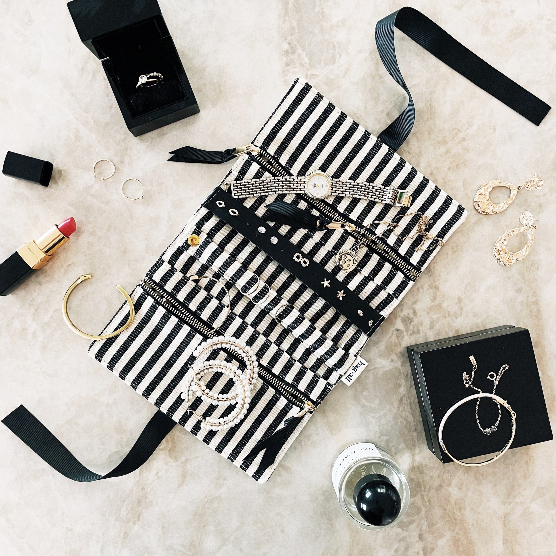 Bag-all Deal Gift Set for Her featuring striped cotton cases for lingerie, makeup, and jewelry, displayed with accessories on white marble surface, black and white design