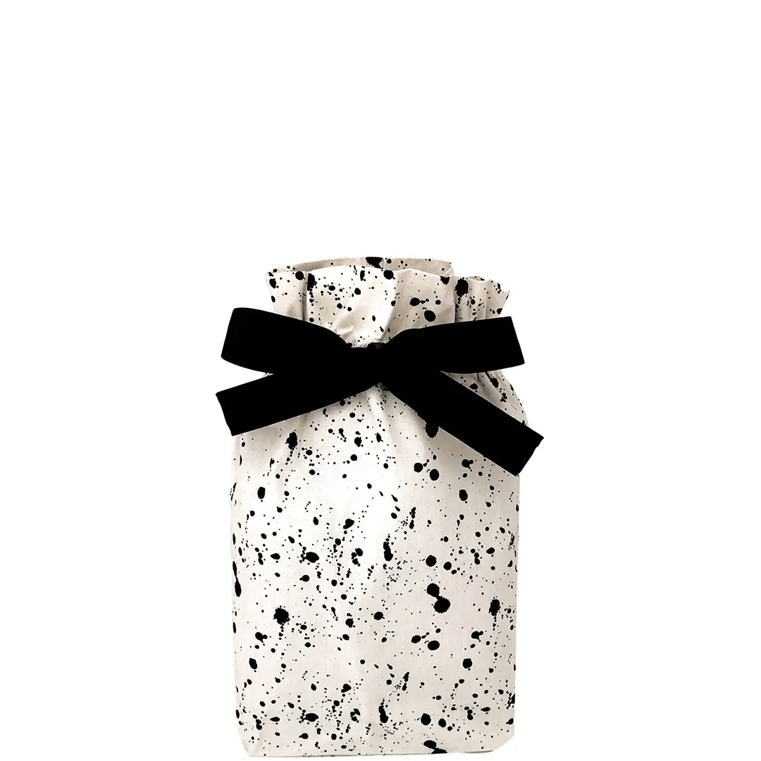 Small Bag-all gift bag with black splatter print tied with black ribbon against white background
