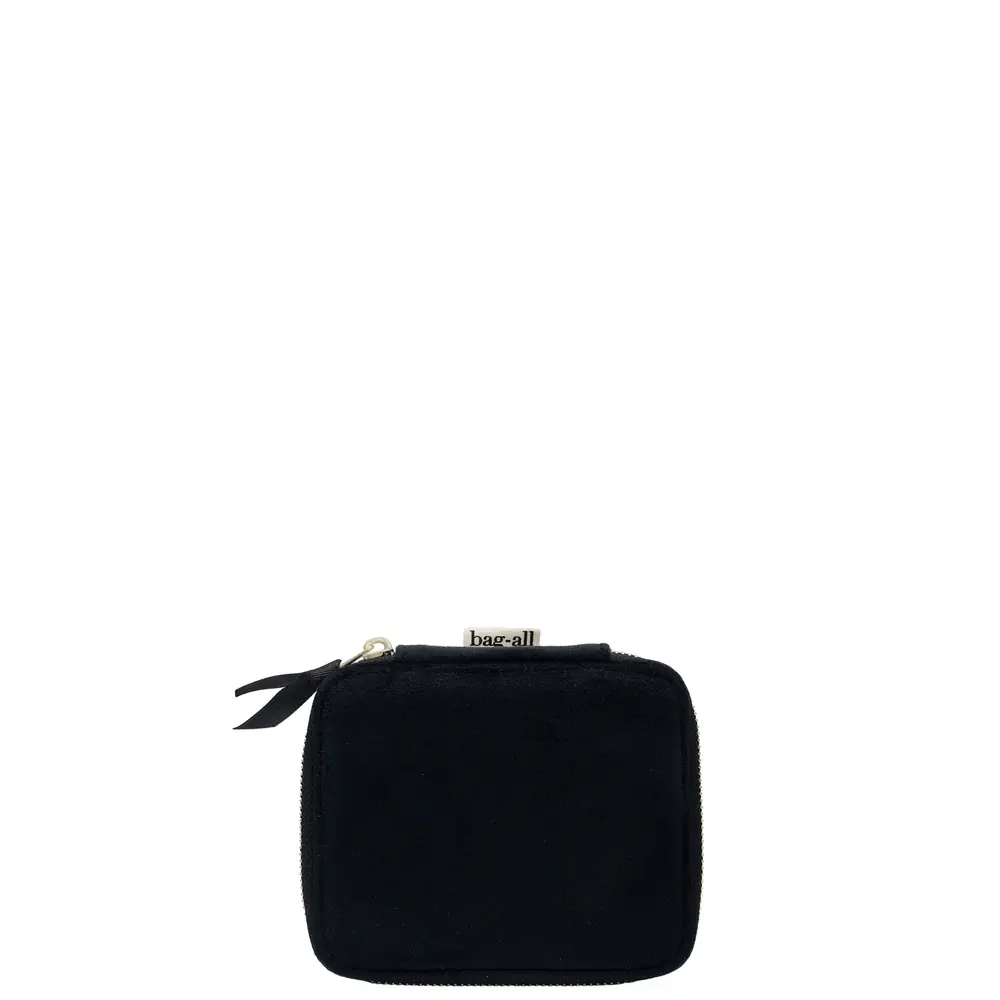 Compact black recycled velvet jewelry box with zipper and Bag-all fabric tag on white background