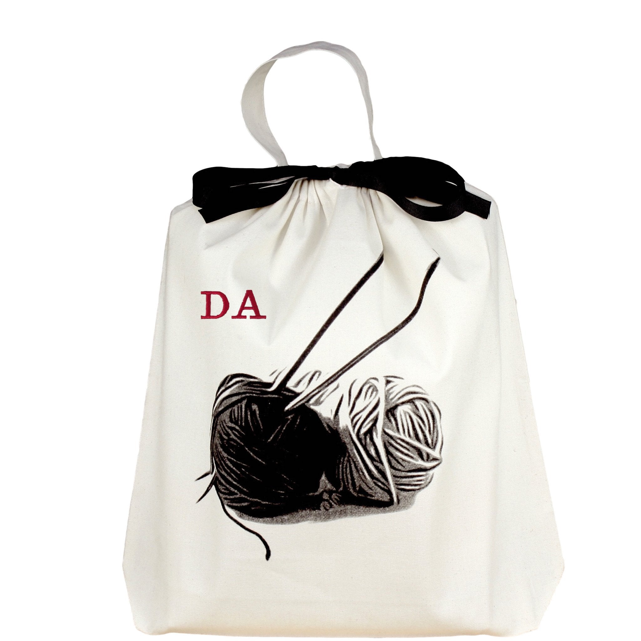 Bag-all Cream Knitting Bag with black and white yarn ball design and monogram option, featuring black bow and carrying handle for portable craft storage