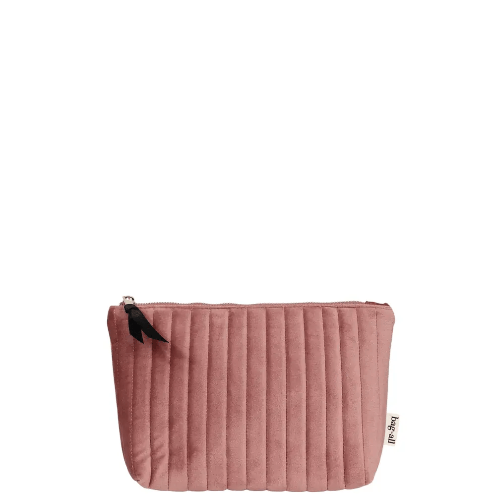 Quilted pink velvet makeup pouch with coated lining and black zipper pull by Bag-all on white background