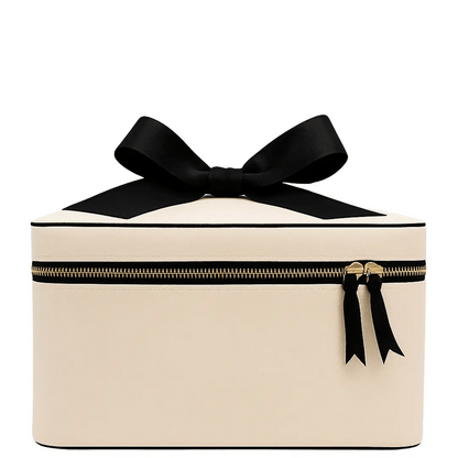 Cream Bag-all medium box makeup and toiletry case with black bow detail and gold zipper on white background