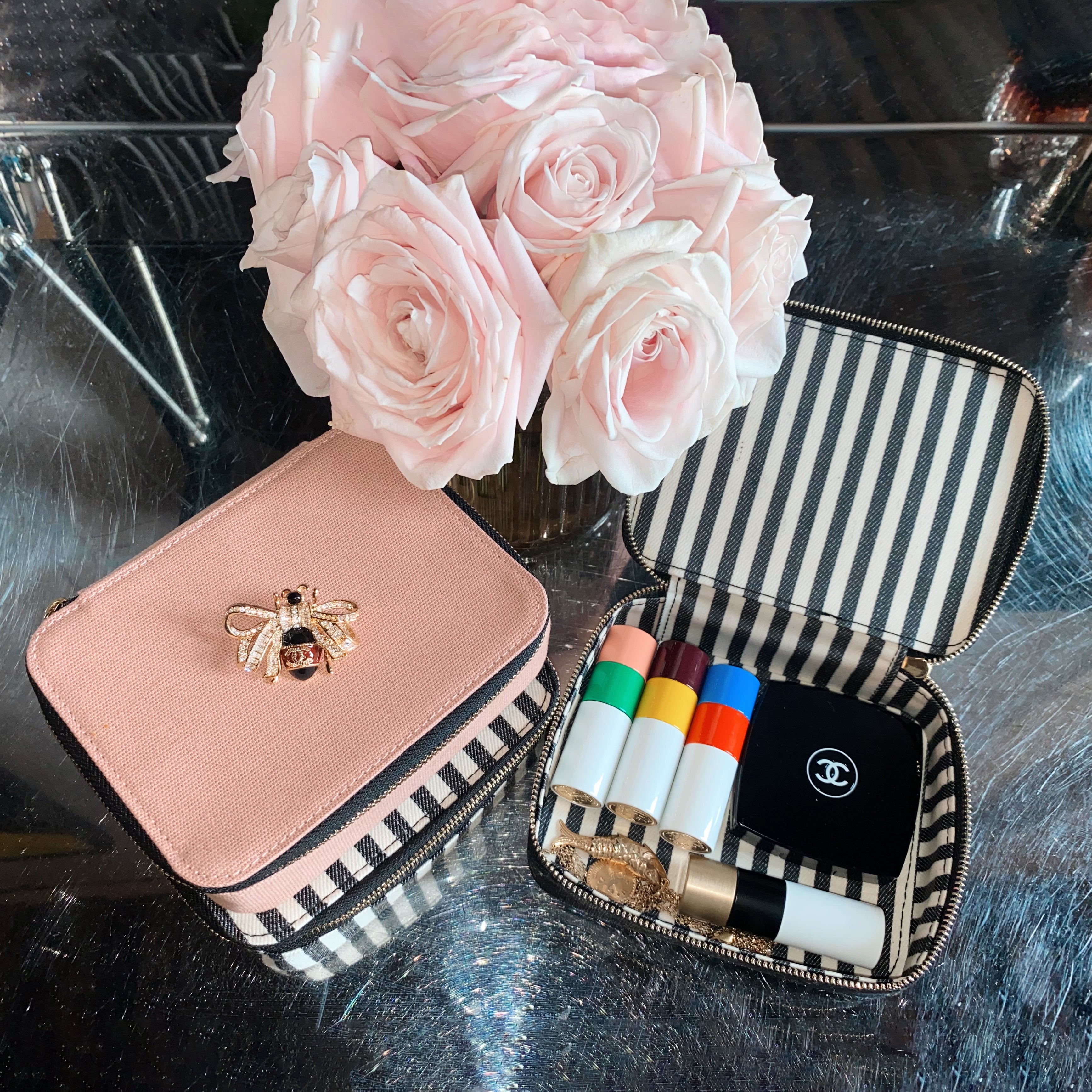 Bag-all Pink Cosmetics/Trinket Box with gold bee detail, striped interior, shown with makeup products and blush roses, perfect for organizing beauty essentials