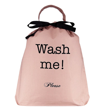 Pink blush laundry organizer bag with black ribbon and Wash me please text by Bag-all