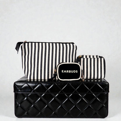 Bag-all striped Handbag Organizer Trio with trinket, makeup, and earbud cases on black quilted box background