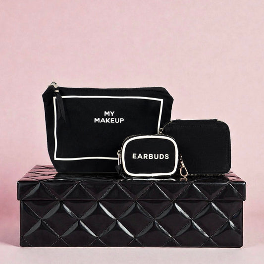 Set of three black Bag-all pouch organizers labeled My Makeup, Earbuds, and zipped case on black textured box against pink background