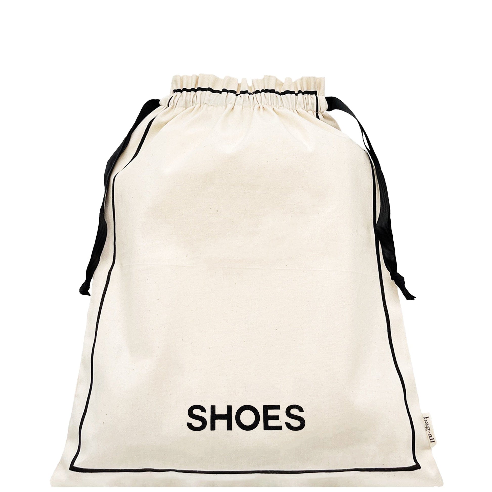 Bag-all Couture Shoe Travel Bag in cream canvas with black drawstring closure and 'SHOES' text print, perfect for organized footwear storage and travel