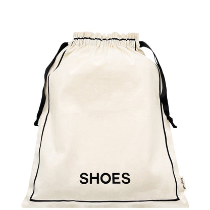 Bag-all Couture Shoe Travel Bag in cream canvas with black drawstring closure and 'SHOES' text print, perfect for organized footwear storage and travel