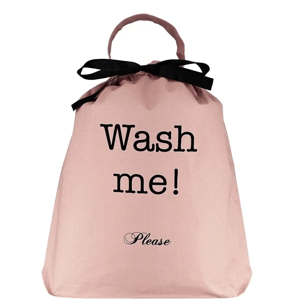 Bag-all pink laundry bag with black bow featuring 'Wash me please' text, perfect for travel and organizing dirty clothes