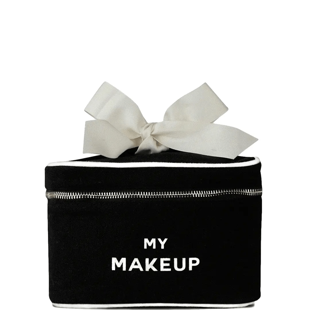Black My Makeup Cosmetic Box with white printed “My Makeup” text, featuring a structured rectangular shape, silver zipper closure, white piping detail, and a large cream fabric bow on top, shown on a clean white background.