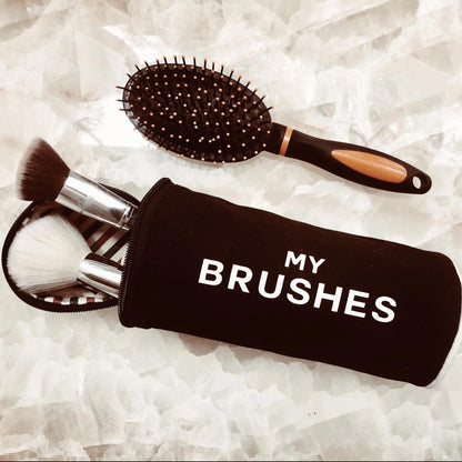 Black Bag-all hair tools organizer pouch with makeup brushes and a brush on a white background for easy storage